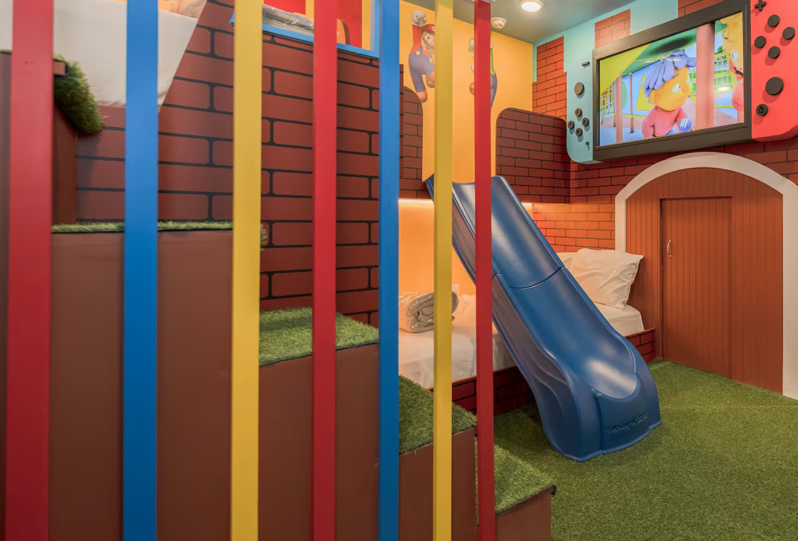 Mario themed kids bedroom with indoor slide and turf flooring in a Central Florida rental home