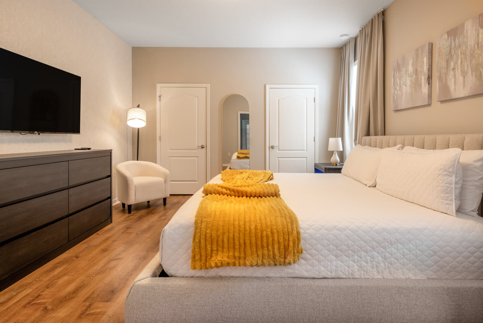Serene primary bedroom with layered bedding in an Orlando luxury residential project